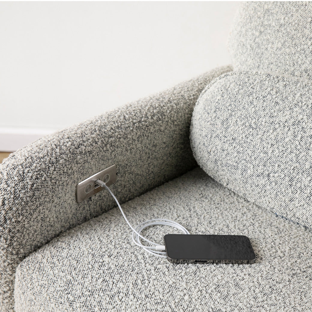 Phone charging in the USB port of the Ubabub Arc Electronic Recliner and Swivel Glider in -- Color_Black White Boucle