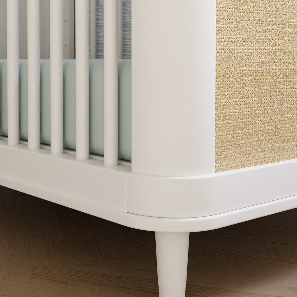 Closeup of The Namesake Marin 3-in-1 Convertible Crib leg in -- Color_Warm White/Honey Cane