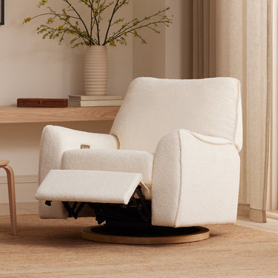Lifestyle view of reclined Nursery Works Sunday Power Recliner and Swivel Glider in --Color_Chantilly Sherpa with Light Wood Base
