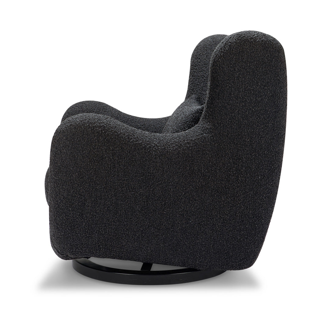 Side view of Nursery Works Solstice Swivel Glider in --Color_Black Boucle with Black Wood Base