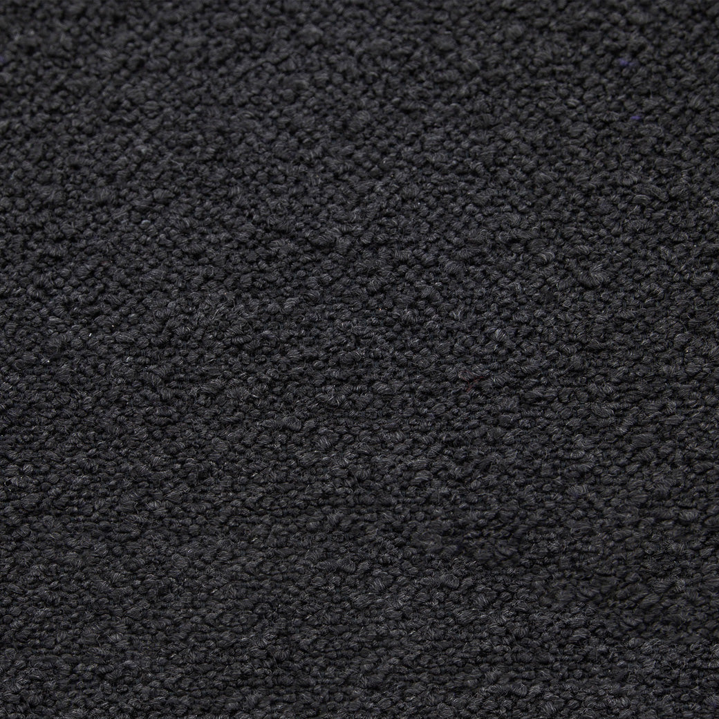 Closeup of Nursery Works Solstice Swivel Glider pattern in --Color_Black Boucle with Black Wood Base