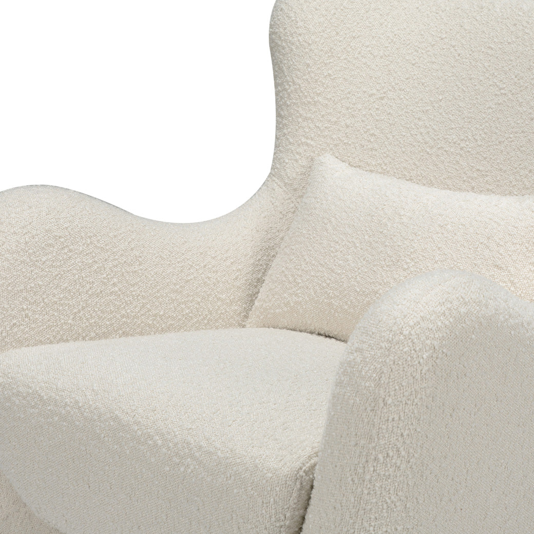 Closeup view of The Nursery Works Solstice Swivel Glider in --Color_Ivory Boucle with Ivory Wood Base