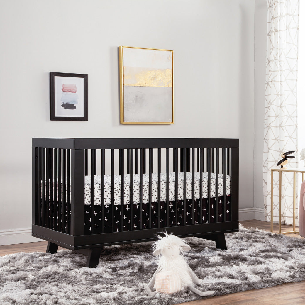Black and White sheets on the mattresses of Babyletto Hudson 3-in-1 Crib in -- Color_Black