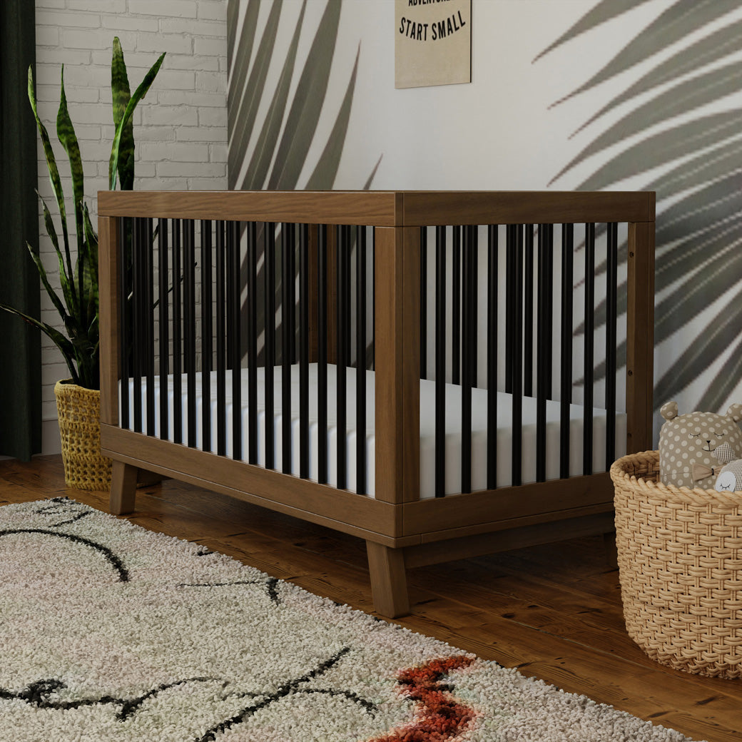 Closeup of the Hudson Crib in a nursery setting -- Color_Natural Walnut/Black