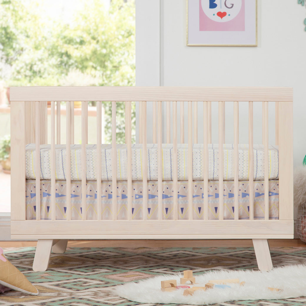 Displayed In a Baby Room with a Profile View of Babyletto Hudson 3-in-1 Crib in -- Color_Washed Natural