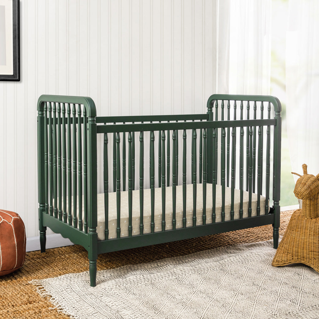 Lifestyle corner view of The Namesake Liberty 3-in-1 Convertible Spindle Crib in -- Color_Forest Green