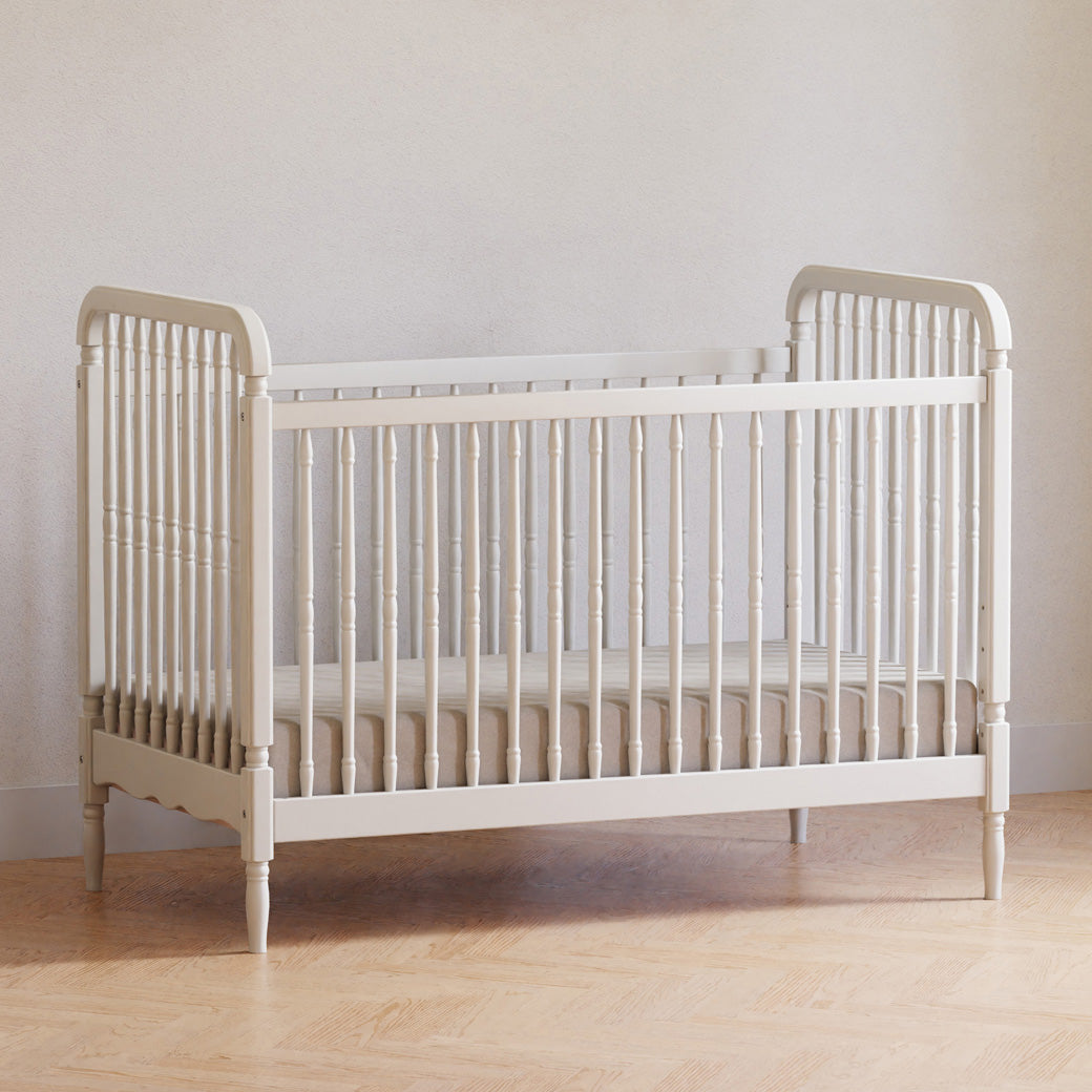 Lifestyle corner view of The Namesake Liberty 3-in-1 Convertible Spindle Crib in -- Color_Warm White