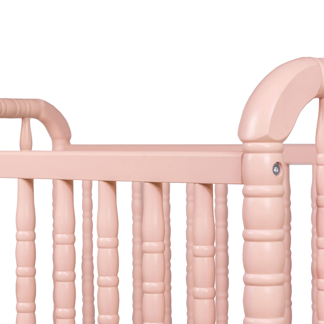 Closeup of the rails  of DaVinci’s Jenny Lind Crib in -- Color_Blush Pink