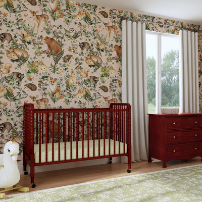 Distant lifestyle view of the DaVinci’s Jenny Lind Crib in a nature themed room in -- Color_Rich Cherry