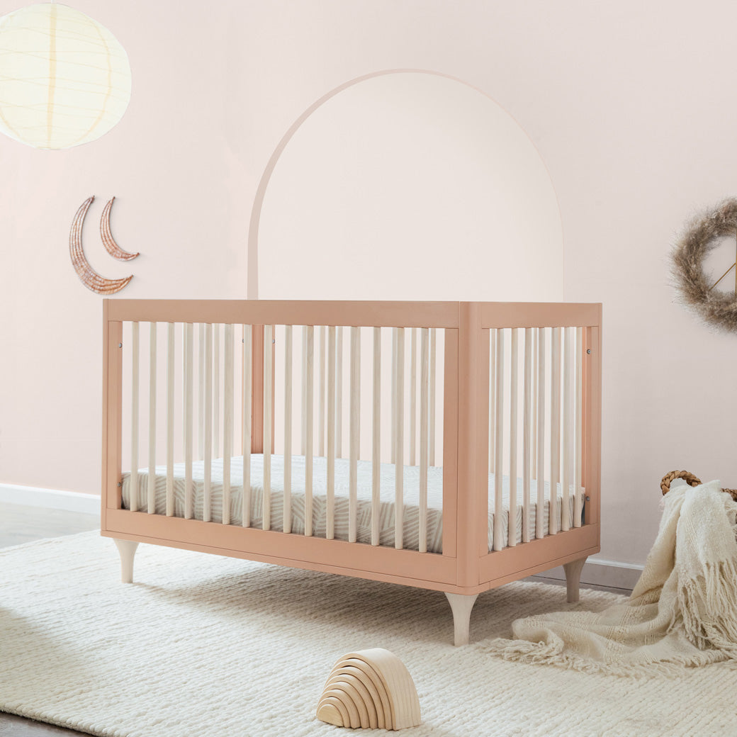 In a baby room with a side view of Babyletto Lolly 3-in-1 Crib in Canyon