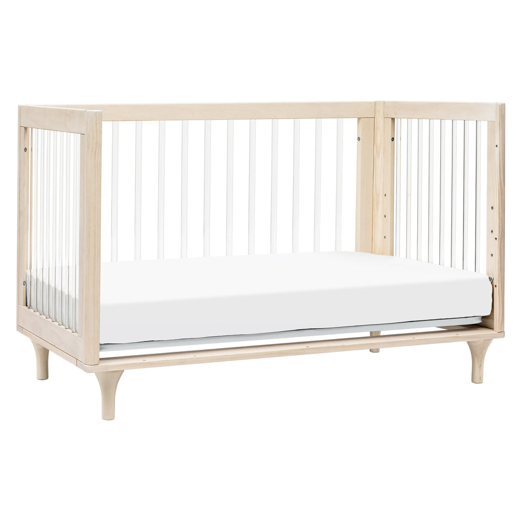 The Babyletto Lolly 3-in-1 Convertible Crib converted into a daybed in -- Color_Washed Natural / Acrylic