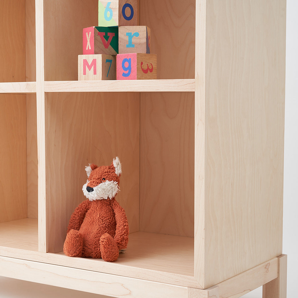 Closeup of Milton & Goose Cubby Bookshelf with toys on it in -- Color_Natural