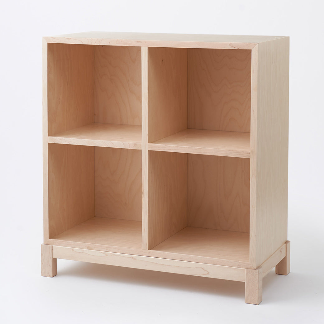 Slight side view of Milton & Goose Cubby Bookshelf in -- Color_Natural