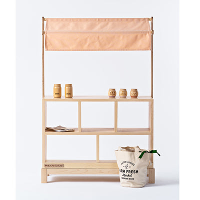 Milton & Goose Market Stand with items on it and tote bag in front  in -- Color_Natural / Pink