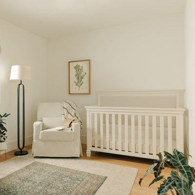Darlington 4-in-1 Convertible Crib in Warm White in a cozy room 