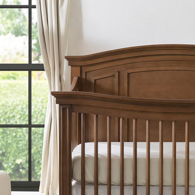 Closeup of the corner of the Namesake's Durham 4-in-1 Convertible Crib in -- Color_Derby Brown