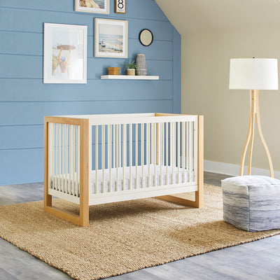 Namesake's Nantucket 3-in-1 Convertible Crib in a blue room  in -- Color_Warm White/Honey