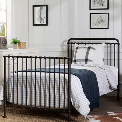 Namesake's Winston 4-in-1 Convertible Mini Crib as full-size next to a dresser in -- Color_Vintage Iron