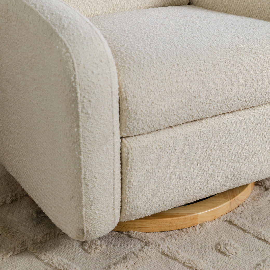 Lifestyle closeup of the bottom part of The Babyletto Nami Glider Recliner in -- Color_Ivory Boucle With Light Wood Base