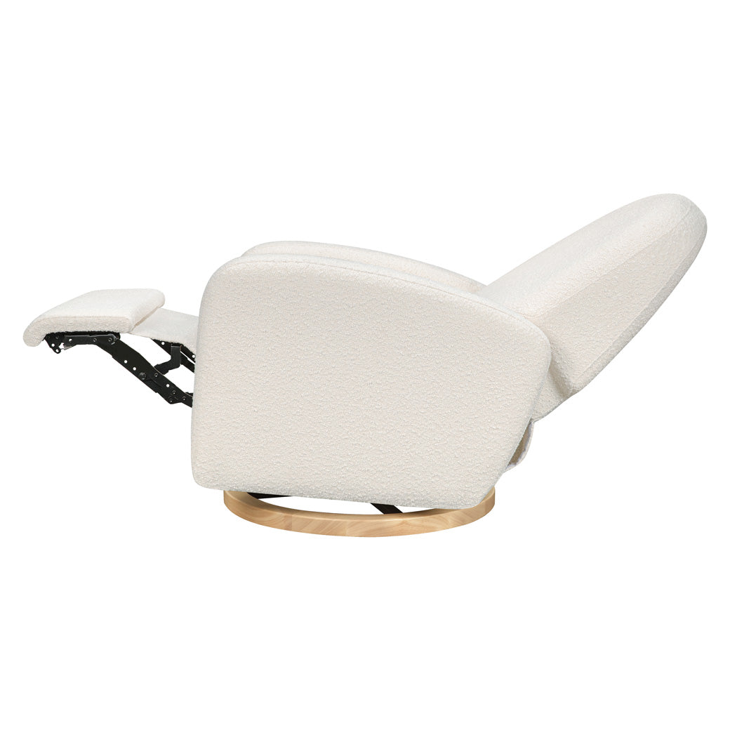 Side view of the reclined Babyletto Nami Glider Recliner in -- Color_Ivory Boucle With Light Wood Base