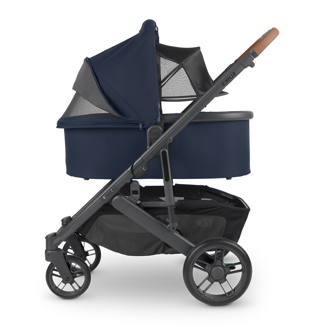 Side view of reversed bassinet with sunshade down on UPPAbaby Cruz V2 Stroller in -- Color_Noa