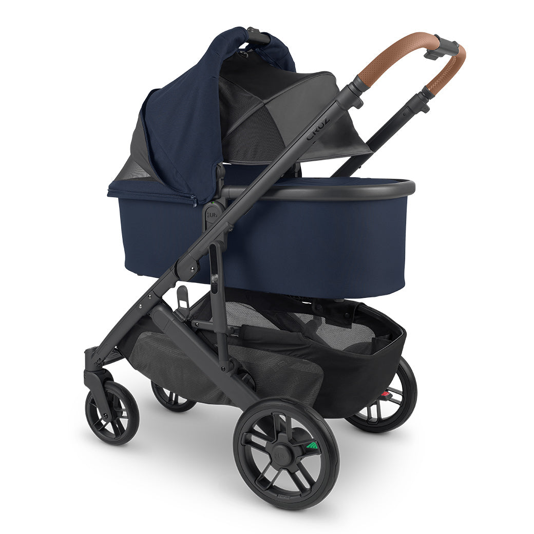 Angled view of bassinet with sunshade down on UPPAbaby Cruz V2 Stroller in -- Color_Noa