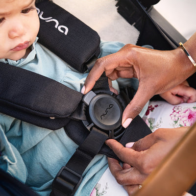 A sweet baby sitting in the Nuna DEMI Grow stroller and PIPA series travel system in -- Color_Caviar / PIPA