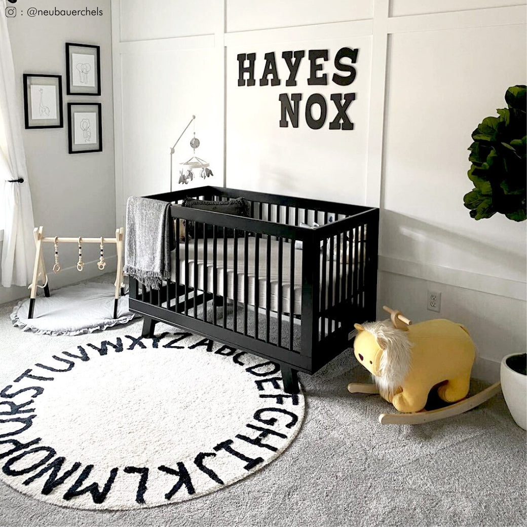 In a baby room with white walls and the Babyletto Hudson 3-in-1 Crib in -- Color_Black