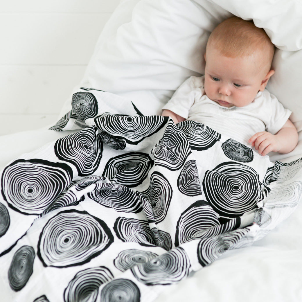 Baby covered with The Etta Loves Sensory Muslin in -- Color_Plant