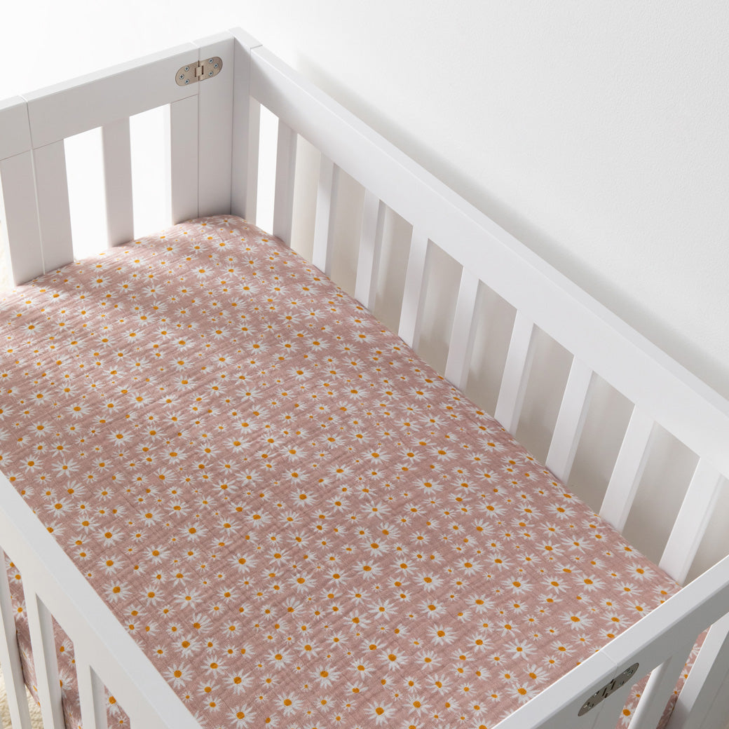 Empty crib equipped with Babyletto's Mini Crib Sheet in -- Color_Daisy