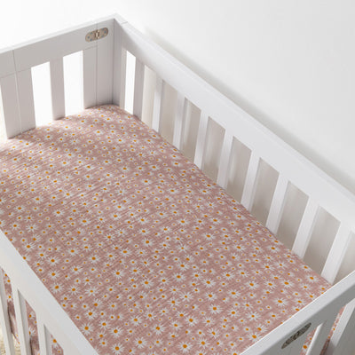 Empty crib equipped with Babyletto's Mini Crib Sheet in -- Color_Daisy