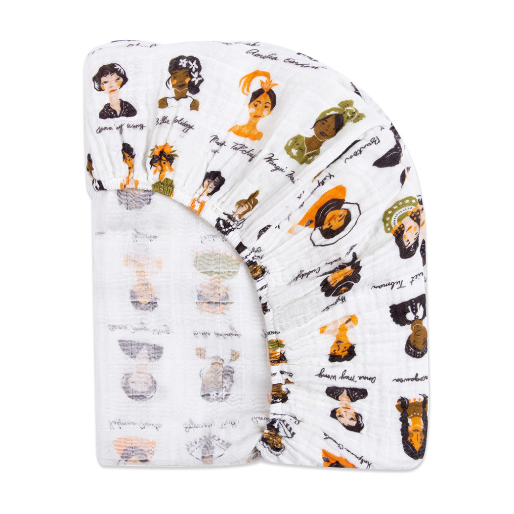 Back corner view of Babyletto's All-Stages Midi Crib Sheet In GOTS Certified Organic Muslin Cotton in -- Color_Women In History