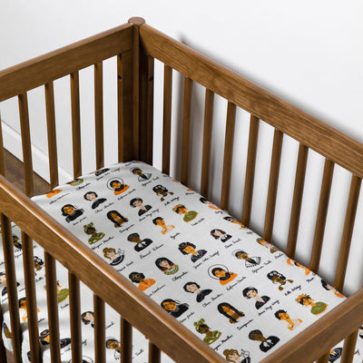 Empty crib equipped with Babyletto's Mini Crib Sheet in -- Color_Women In History