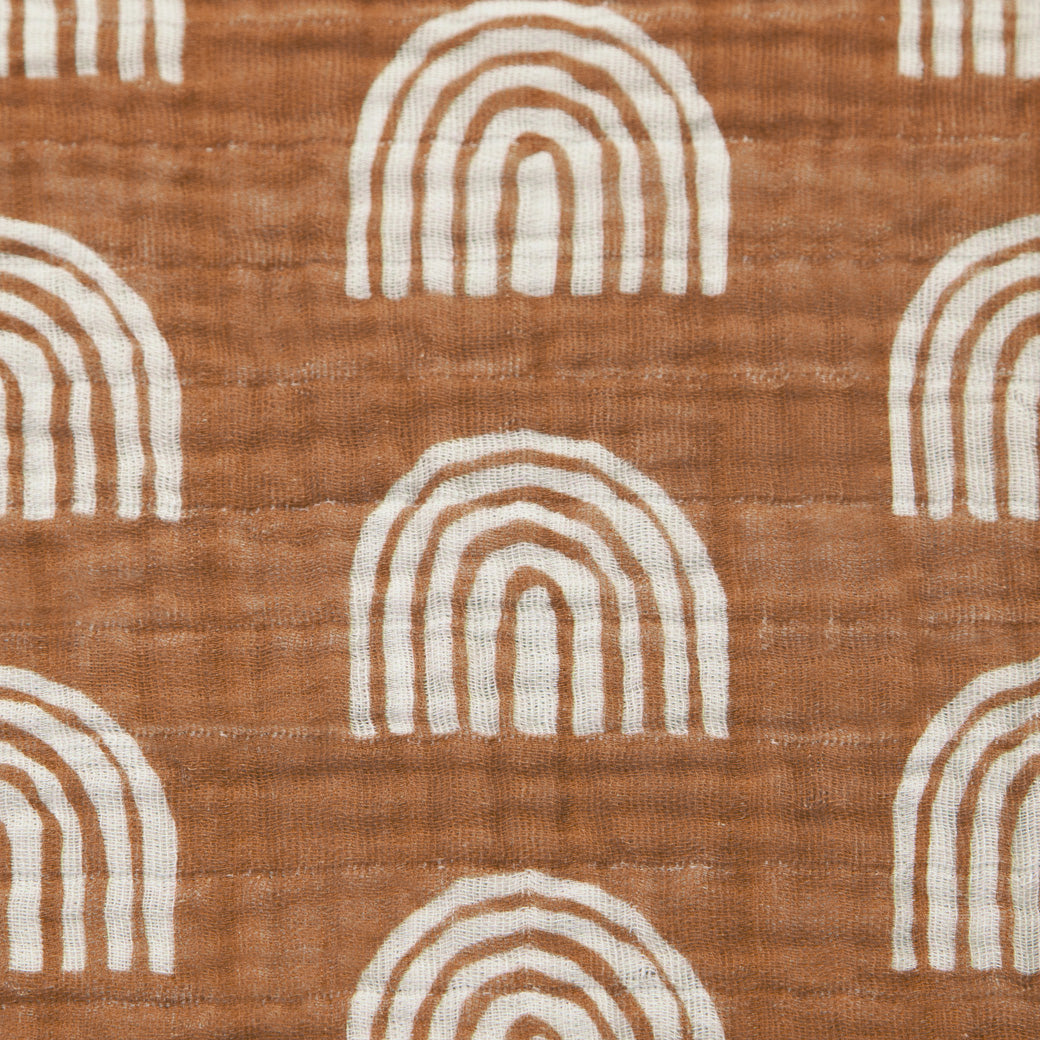 Closeup of the pattern of the Babyletto's Crib Sheet in GOTS Certified Organic Muslin Cotton in -- Color_Terracotta Rainbow