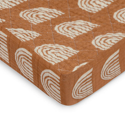 Corner of Babyletto Quilted Changing Pad Cover In GOTS Certified Organic Muslin Cotton in -- Color_Terracotta Rainbow