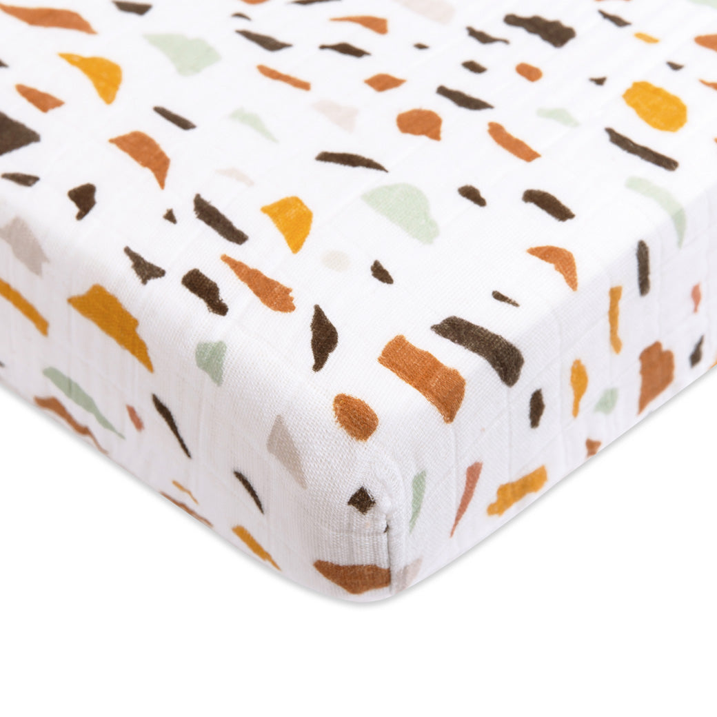 Corner closeup of Babyletto's Mini Crib Sheet in -- Color_Terrazzo