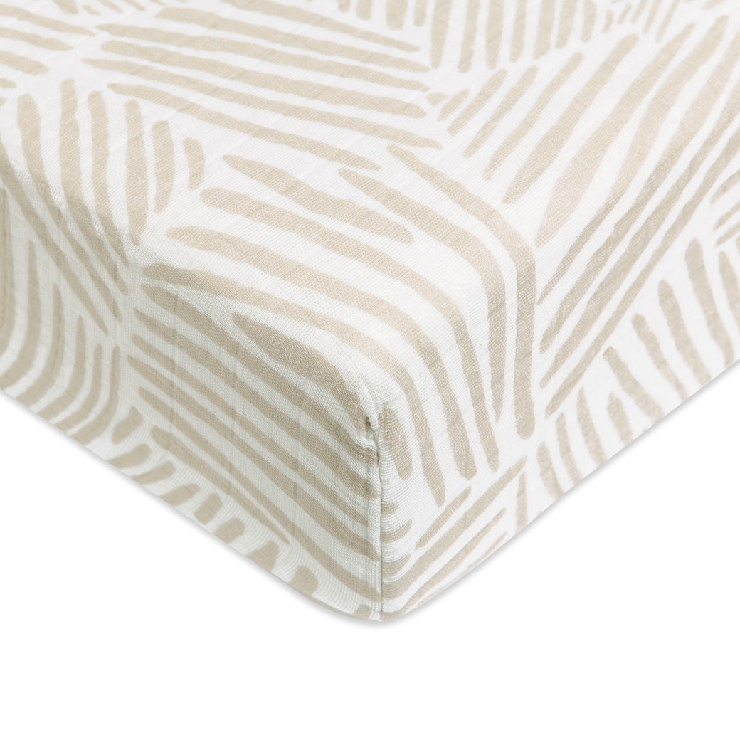 A closeup of the Babyletto's Crib Sheet in GOTS Certified Organic Muslin Cotton corner in -- Color_Oat Stripe