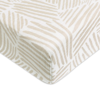 A closeup of the Babyletto's Crib Sheet in GOTS Certified Organic Muslin Cotton corner in -- Color_Oat Stripe