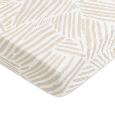 Corner closeup of Babyletto's Mini Crib Sheet in -- Color_Oat Stripe