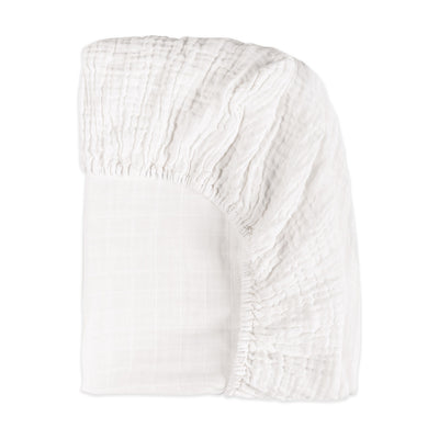 Back corner view of Babyletto's All-Stages Midi Crib Sheet In GOTS Certified Organic Muslin Cotton in -- Color_White