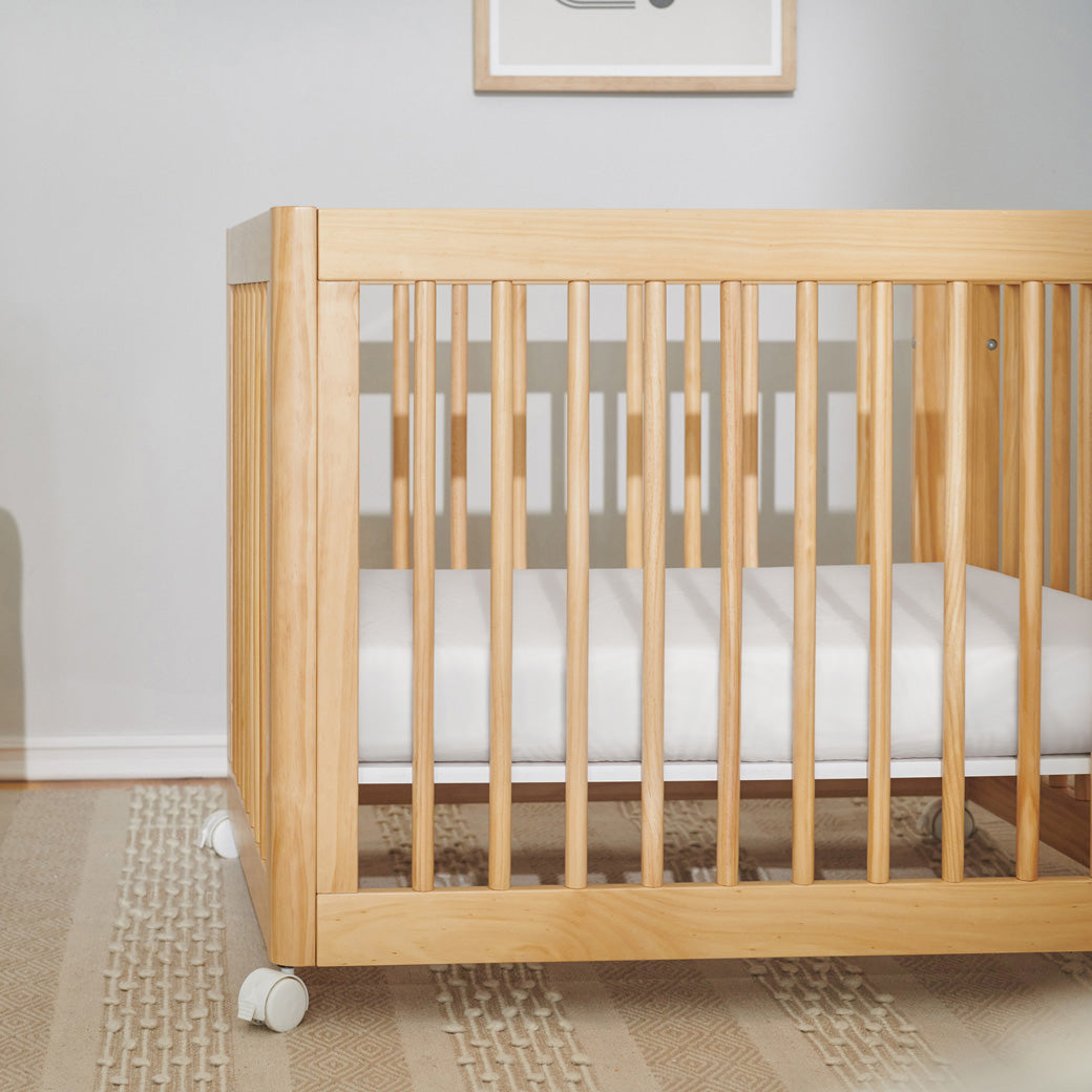 Babyletto's All-Stages Midi Crib Sheet In GOTS Certified Organic Muslin Cotton in a crib in -- Color_White