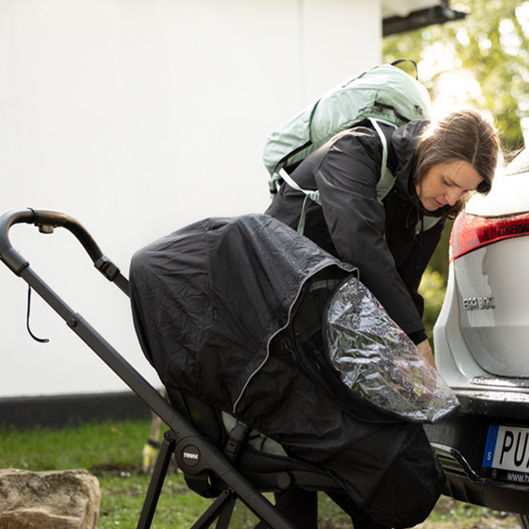 Mother zips down the Thule Shine All Weather Cover -- Lifestyle