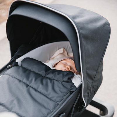Beautiful little baby sleeping in the Thule Shine Stroller in -- Color_Black