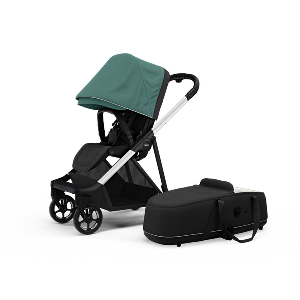 Side view of the Thule Shine Stroller in -- Color_Mallard Green with the Thule Shine bassinet