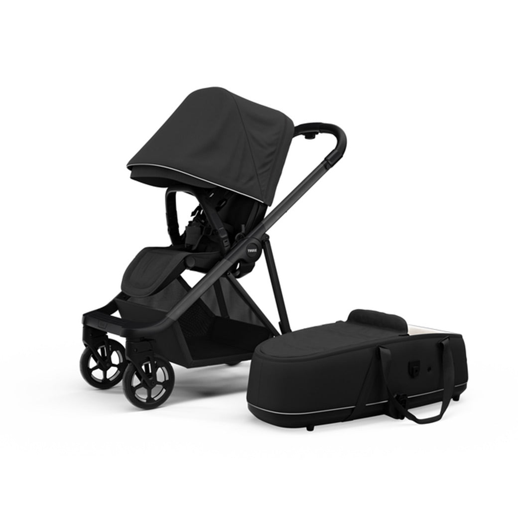 Side view of the Thule Shine Stroller in -- Color_Black with the Thule Shine bassinet