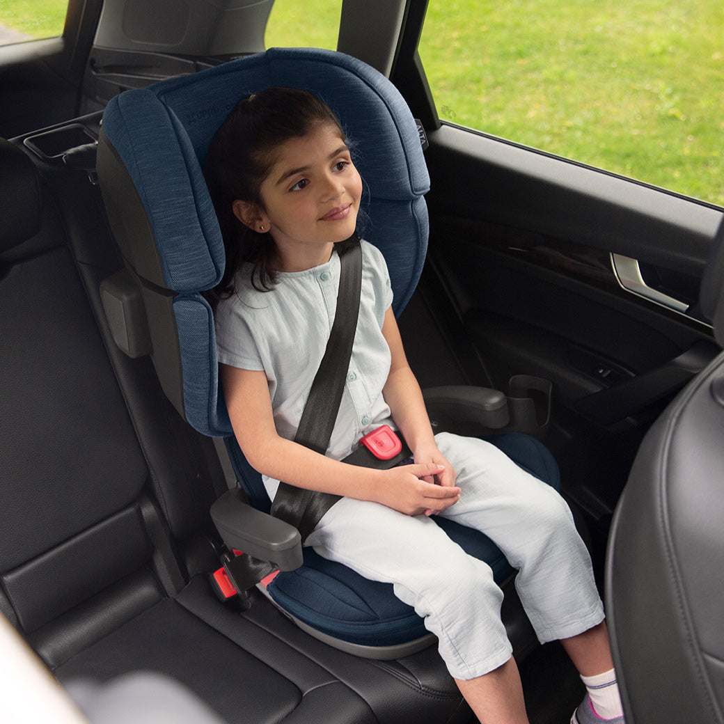 A child sitting in the UPPAbaby Alta Booster Seat in -- Color_Noa