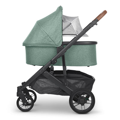 Reversed bassinet with sunshade down on the UPPAbaby Cruz V2 Stroller in -- Color_Gwen