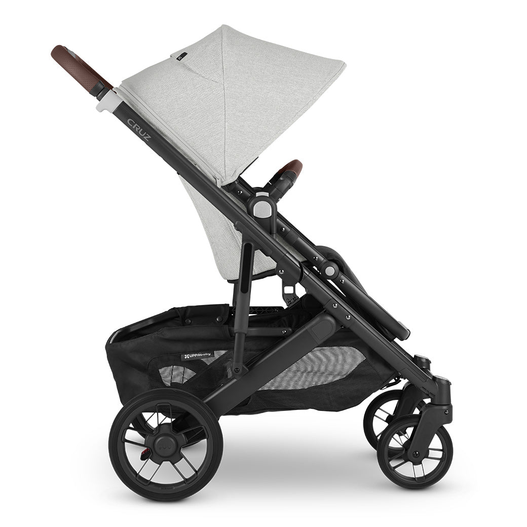 Side view of the forward facing configuration of uppababy cruz v2 stroller with black frame and grey chenille fabric -- Color_Anthony