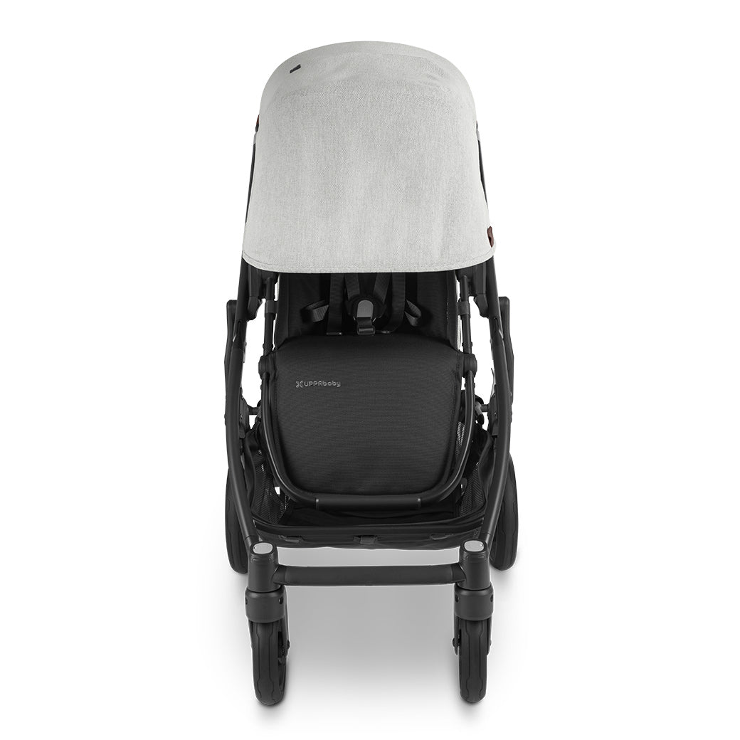 Front view of front-facing uppababy cruz v2 stroller with sun shade fully extended; black frame and grey chenille fabric -- Color_Anthony