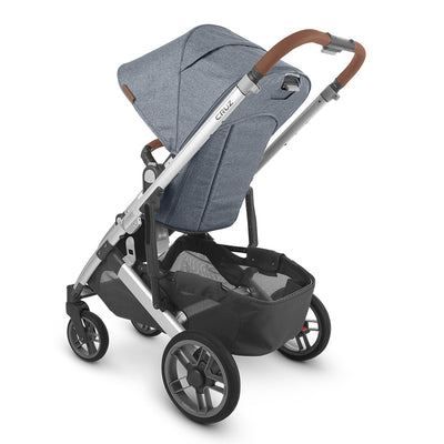 Rear-view of the uppababy CRUZ V2 stroller showing the ample storage basket and leatherette handlebar details -- Color_Gregory